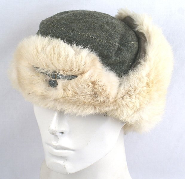 German WWII Army winter hat: E-186 German WWII Army winter hat. O.D. wool with a padded lining. Rabbit fur-lined forehead, ears and neck pull-down cover. Period sewn eagle/swastika to turned-up front flap. II
