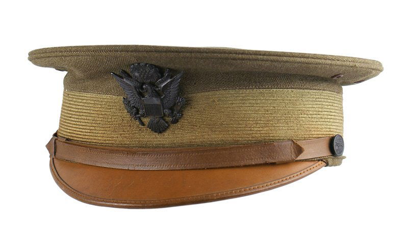U.S. WWI officer peaked cap: E-192 U.S. WWI officer's peaked cap. OD body with a ribbed lighter OD band. Darkened US eagle badge and side buttons. Brown leather visor, chinstrap and sweatband. Liner shows little wear. II+