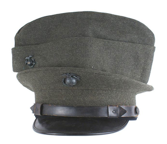 U.S. WWII USMC lot peaked cap o'seas cap: E-205 U.S. WWII USMC lot: (1) EM peaked cap. O.D. wool with a black leather chinstrap and visor. Darkened EGA insignia. Excellent sweatband and lining. (2) O.D. wool o'seas cap. With EGA. Named to "D.