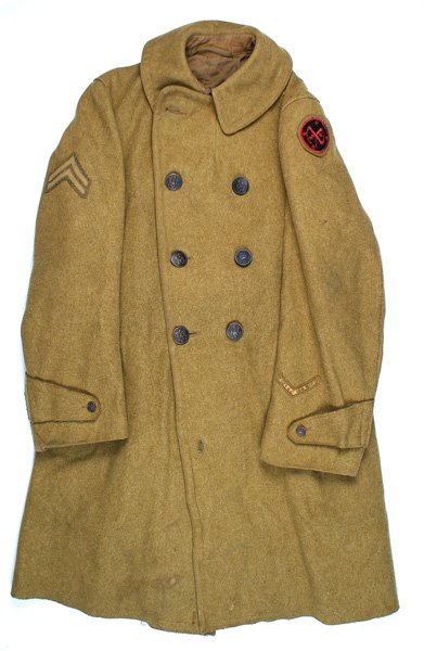 U.S. WWI EM 27th Division overcoat: F-062 U.S. WWI EM 27th Division overcoat. O.D. wool with 8 large darkened eagle buttons. Embroidered NY "patch" on sleeve on shoulder, o'seas chevron on left cuff and Corporal chevron on right shoulde