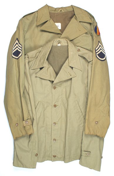 Lot 2 Second pattern M1941 Field Jackets: F-103 Lot of 2 Second pattern M1941 Field Jackets: (1) O.D. with two slant pockets and button tabs on the cuffs and waist. Lined. Maker's label dated "1943". About excellent. (2) Same with Staff Serge