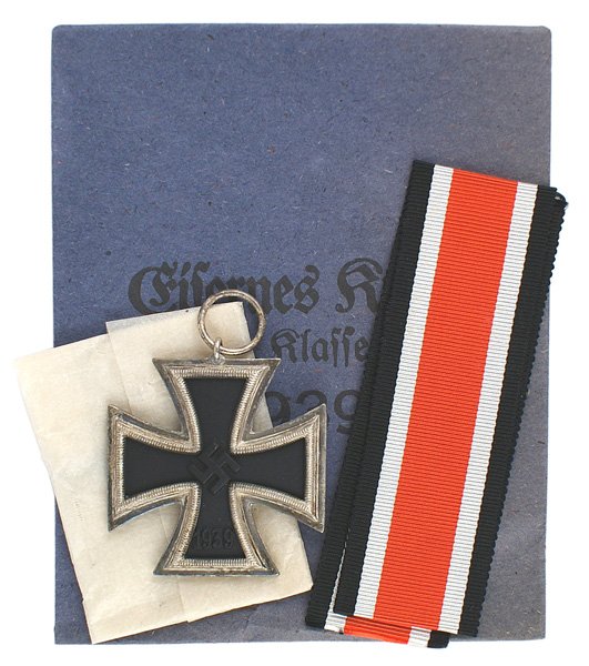 German WWII 1939 Iron Cross 2nd Class: B-054 German WWII 1939 Iron Cross - 2nd Class with a high swastika and patina on frame. Maker's number "1" (Deschler & Sohne in Munich) on ring. With ribbon, paper wrapping and packet envelope. I