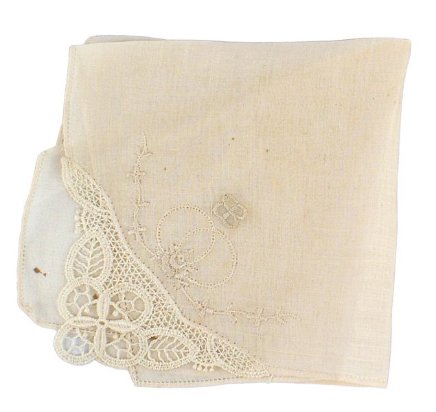 Eva Braun delicate linen handkerchief: A-026 Eva Braun delicate linen handkerchief 10 1/4" x 10 1/4". Small perforation along border. One corner has fine open circular panels with floral design. Also a relief embroidered "butterfly" patter
