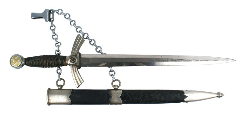 German WWII Luftwaffe 1st Model dagger: D-012 German WWII Luftwaffe 1st Model dagger. Gilt brass "sun wheel" swastika on a silvered round pommel. Wire-wrapped leather grip (shows some wear). Turned-down "wings" corssguard with a "sun wheel"
