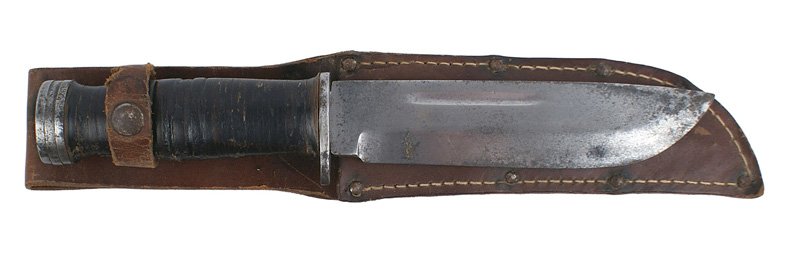 U.S. Cattaraugus Commando knife: D-036 U.S. Cattaraugus Commando knife. Oval steel pommel and short crossguard on a leather rings grip. Wide 6" blade shows light pitting. Marked "Cattaraugus 225 Q". 1" split at the top side of the le