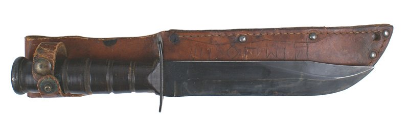 U.S. WWII USMC combat knife: D-046 U.S. WWII USMC combat knife, crossguard marked "USMC" and "CAMILLUS, N.Y.". 90% of the dark blue finish on the blade remains. Scabbard has scratched name "Jim Joslin" - shows some wear. II