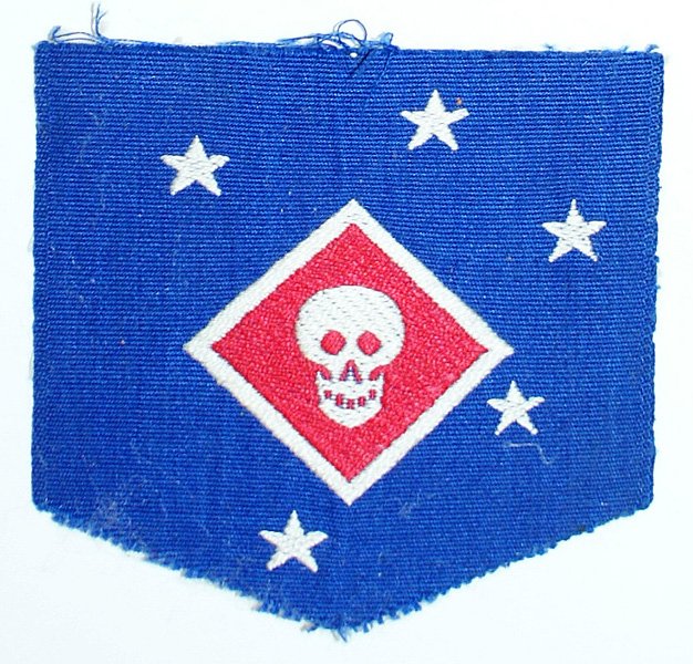 USMC WWII Raider MAC shoulder patch: H-141 USMC WWII Raider "MAC" shoulder patch. 4 white stars on a blue field with a white outlined red diamond holding a white skull. Theatre made smaller size with a gauze backing. (From the possession