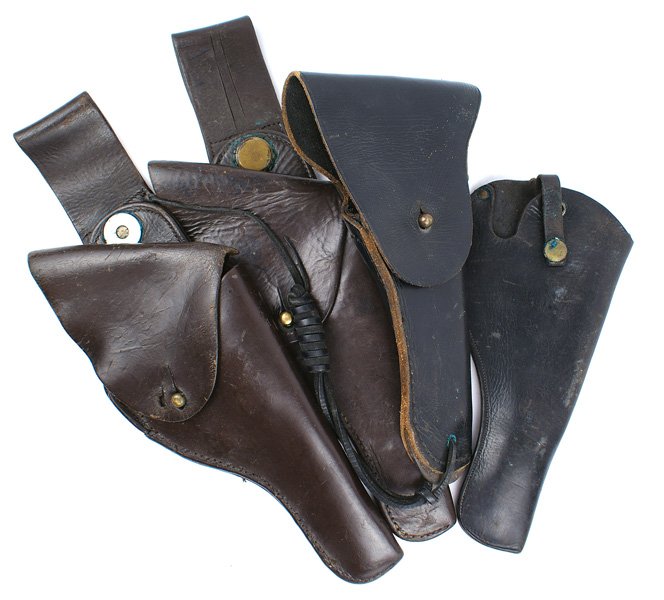 Lot of 4 pistol holsters U.S. 45 etc: M-020 Lot of 4 pistol holsters: (1) U.S. 45 cal auto. Marked "BUCHEINER" (2) Two military revolver holsters - one with a swivel belt attachment and one open-top. II