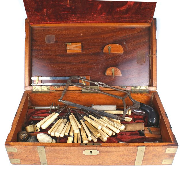 Antique surgeon kit pre Civil War: K-030 Antique surgeon's kit. Original pre-Civil War wood chest with brass bands, corners and locking hooks. Contents are a wide mixture of implements (some later) to include a hand saw marked "EVANS &
