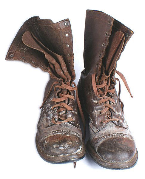 U.S. WWII Paratrooper leather boots: N-065 U.S. WWII Paratrooper leather boots. High lace-up type with distinctive toe cap and back stay. Rubber soles and slanted heels. Inside lining named to "Duilio Auda" and a serial number. Shows wea