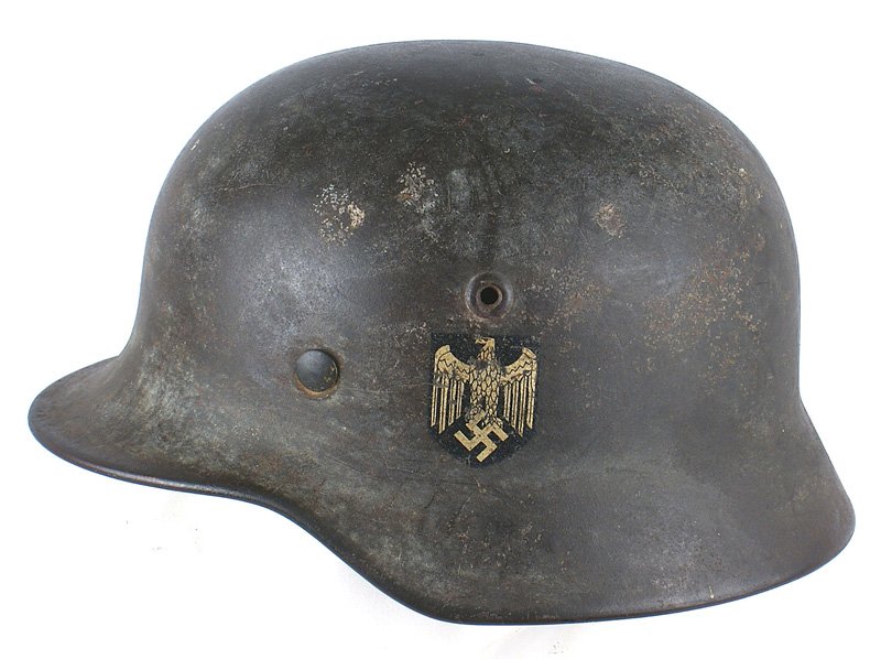 German WWII Army M1940 helmet: E-125 German WWII Army M1940 single decal helmet. Eagle decal has several minor "chips" to the body and wings. Helmet still retains some of the original light green camouflage. Liner shows much wear a