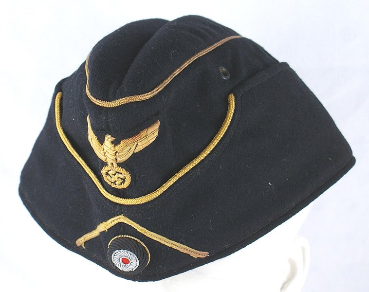 German WWII Panzer General o'seas cap: E-201 German WWII Panzer General o'seas cap. Quality black wool body with gold wire cord piped front and crown. Relief gold bullion eagle/swastika and a high relief embroidered rosette under the gold 