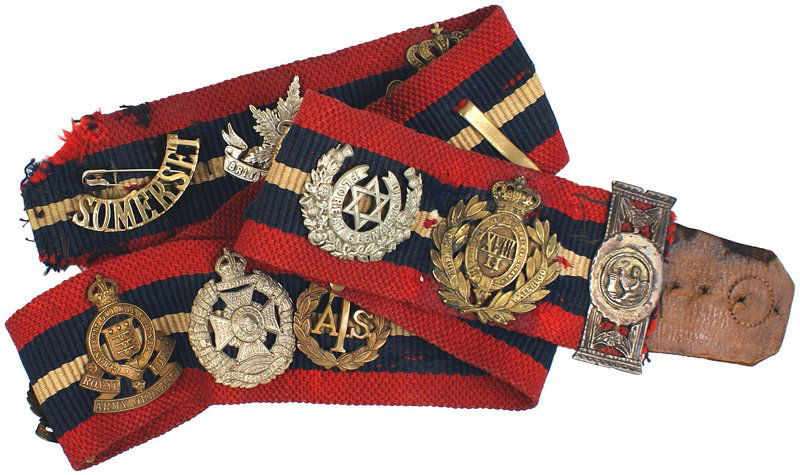 British WWI cap badges belt: E-250 British WWI red/blue/white woven belt with 17 attached period metal cap badges. Includes: 30th Bn. CEF - 2nd B.C., York and Lancaster Regiment, RAF Other Ranks, Durham Light Infantry 6th Bn., Pi