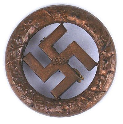German WWII Gau Munich Badge: B-043 German WWII Gau Munich Commemorative Badge of 9 November 1923. Bronze circular oak leaf wreath holding a cut-out swastika with "1933" - not maker marked. II