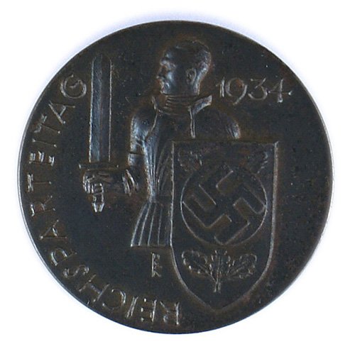 German WWII 1934 REICHSPARTEITAG Badge: B-044 German WWII "1934 REICHSPARTEITAG" Badge - Knight with a broadsword and swastika decorated shield. Heavy type - made by "DESCHLER & SOHN - MUNCHEN 9". Type given to dignitaries. II+