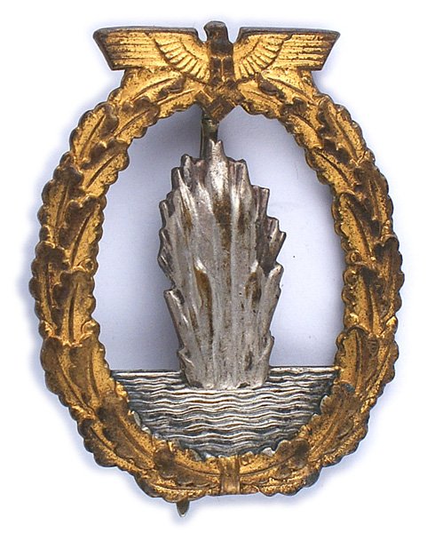 German WWII Navy Minesweeper Badge: B-211 German WWII Minesweeper Badge. Much of the gold finish remains except for the high points of the oak leaves which have darkened. Silver spray of water. Reverse is marked "FEC. OTTO PLACZEK BERLI