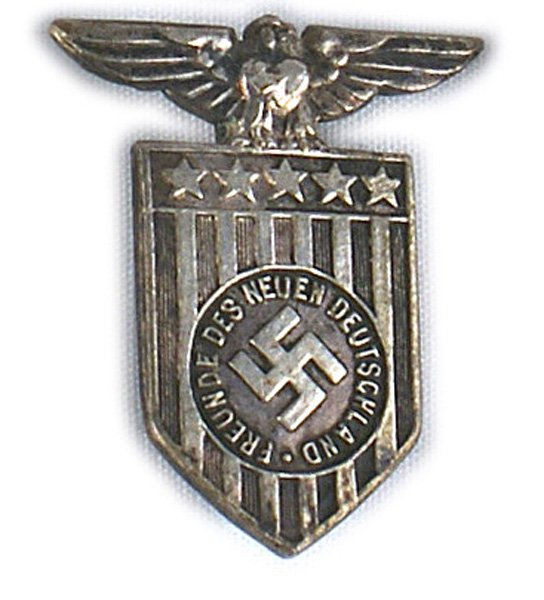Nazi German American Bund silver badge: B-314 German American Bund silver badge. Eagle surmounted American shield with a ciruclar recessed center bearing a relief swastika and "FREUNDE DES NEUEN DEUTSCHLAND" (FRIENDS OF THE NEW GERMANY).Ver