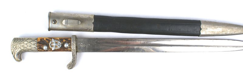 German WWII Police sidearm dagger: D-023 German WWII Police sidearm. Nickeled detailed eagle head pommel and oak leaf decorated turned-up guard. Eagle/swastika/wreath insignia set into the stag grip. Clean 13 1/8" blade marked with a l