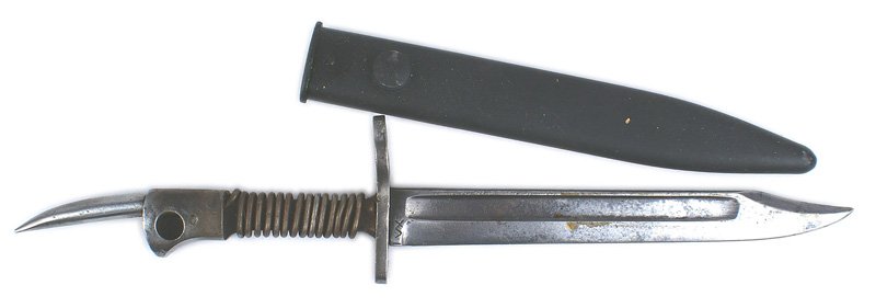 British altered bayonet: D-101 British altered bayonet. Grip was made smaller and a heavy wire wrapped around the exposed tang. 2 1/4" spike has been added to the pommel. 7 7/8" cut-down blade is pitted and darkened. Marked "