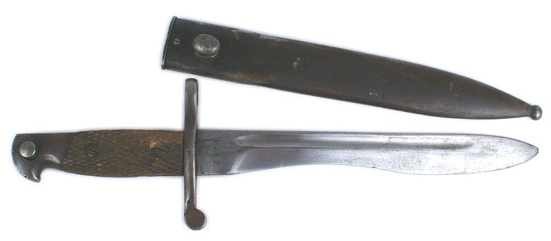 Spanish M1941 Mauser bayonet: D-107 Spanish M1941 Mauser bayonet. Worn and darkened steel pommel and crossguard/muzzle ring. 1" chip out of the checkered wood grips. 9 3/4" bolo-type blade narrows at the center and widens towards 