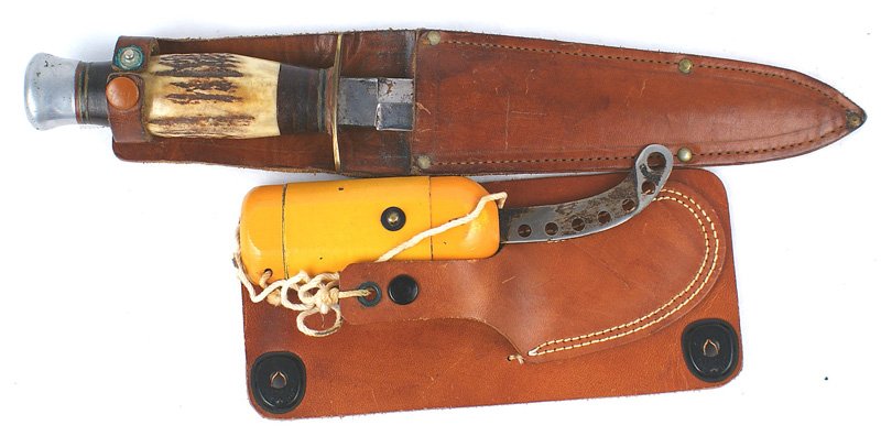 Lot of 2 U.S. WWII knives: D-167 Lot of 2 WWII knives: (1) Combat knife - with leather washers/center stag portion, grip. Rounded aluminum pommel and oval brass guard. 6", double-edged, stiletto-type blade. Some minor wear on t