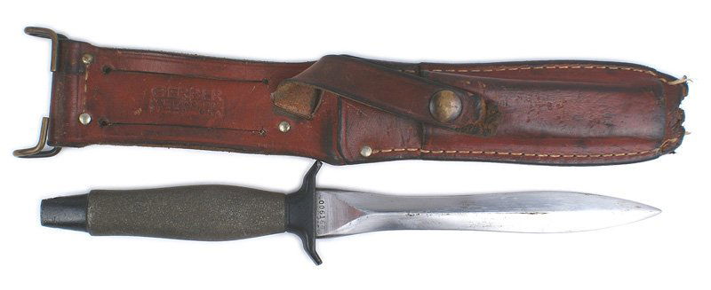 Early Gerber Mark II combat knife: D-219 Early Gerber Mark II combat CT 2 (Cat's Tongue Type 2) 1970-71 combat knife. Gray handle with a black painted pommel and guard. 6 3/4" clean "wasp waisted" type blade. Marked "006166" and with s