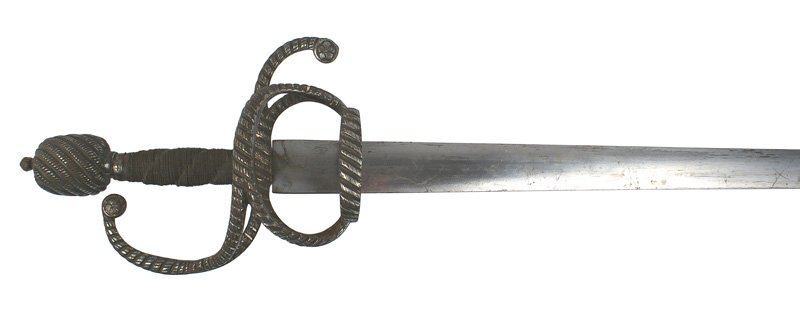 Early German swept hilt sword 16th Century: R-006 Early German swept hilt sword. Large barrel-shaped linear chiseled pommel with a small round finial. Tightly wrapped narrow wire grip with three diagonal indentations. One-piece steel guard cons