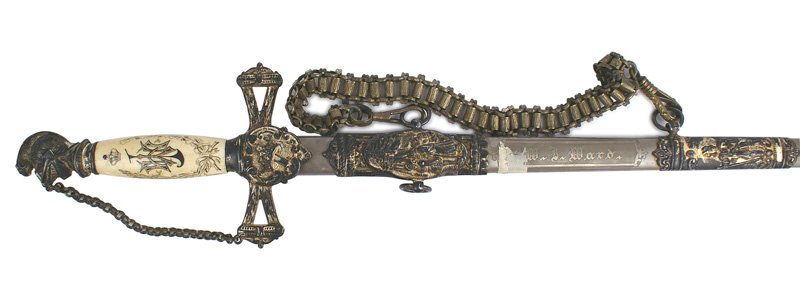 Knights Templar 32nd Commadery dress sword: K-109 Knights Templar 32nd Commadery dress sword. Aged toned silver Knights helmet pommel and chain guard. Pierced crossguard with shield-shaped langet bearing a relief crown/cross. Aged bone grip etc