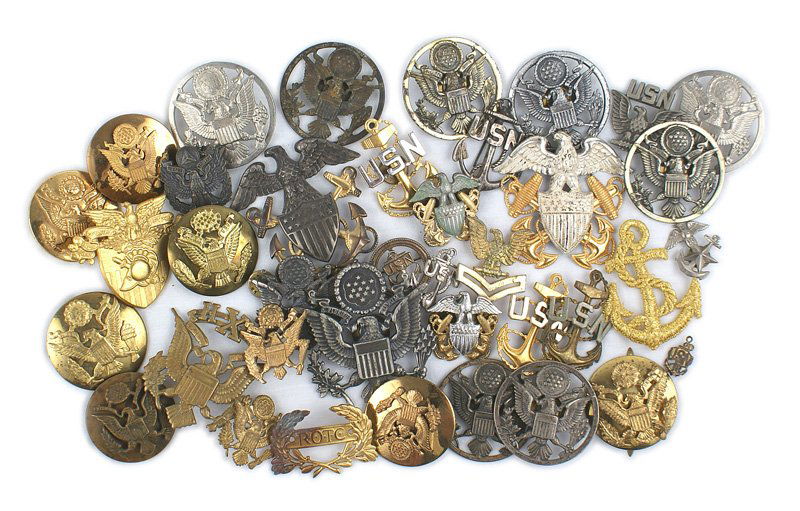 Lot of U.S. WWII and later, mostly peaked cap insignia: E-159 Lot of U.S. WWII and later, mostly peaked cap insignia. Includes: (1) Twelve Army - EM, West Point and School Badge. (2) Fourteen Navy - two officer (one in sterling), NCO and miscellaneous cap