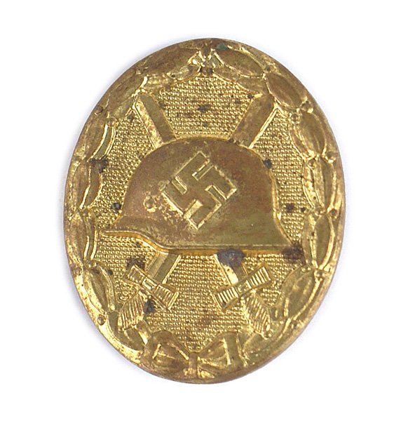 German WWII Gold Wound Badge: B-079 German WWII Gold Wound Badge. Heavy type, retaining 75% of the original gilt finish .Reverse marked "L/63" (Franz Klamt & Sohne in Gablonz). Wide vertical pin. Scarce. II