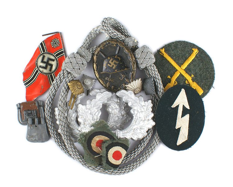 German WWII lot Wound Badge etc: B-129 Miscellaneous German WWII lot: (1) Wound Badge - Black. Shows some wear. (2) Two Army metal oak leaf wreaths for a peaked cap. (3) Army Officer's silver cap cord. (4) Lineol toy soldier war flag