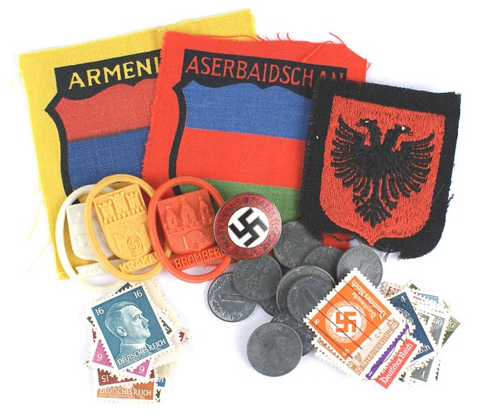 German WWII lot NSDAP Badge coinsVolunteers Shields: B-131 Lot of miscellaneous German WWII items: (1) N.S.D.A.P. enameled Member's Badge. Marked "RZM" and "M1/34". (2) Three WHW city Contributor's badges (includes "KRAKAV"). (3) Twelve Third Reich zinc