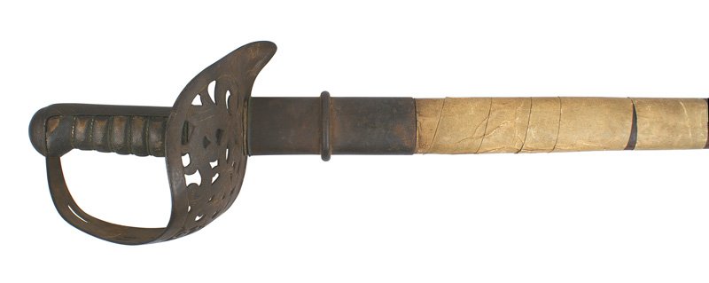 British M1895 Infantry officer sword: D-029 British M1895 Infantry officer's sword. Iron pommel/backstrap and large pierced basket guard with a crown over "VR" and floral designs. Wire wrapped leather grip shows wear. 33" straight blade i