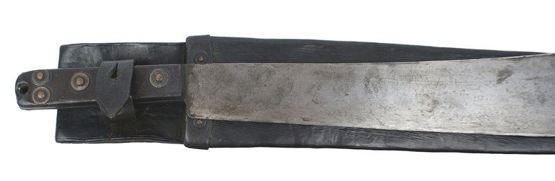 British WWII military machete: D-056 British WWII military machete. Dark black grip with 5 rivets. 15" blade (marked "...SHEFFIELD ENGLAND...1937") shows graying and use. Black leather scabbard as above - marked with a broad arrow
