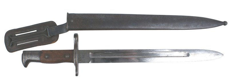 U.S. Krag M1892 bayonet: D-061 U.S. Krag M1892 bayonet. Steel pommel and crossguard. Wood grips. Fairly clean 11 5/8" blade stamped "US" and "1900". Blued steel scabbard with a swivel metal belt loop and leather spacer (dated