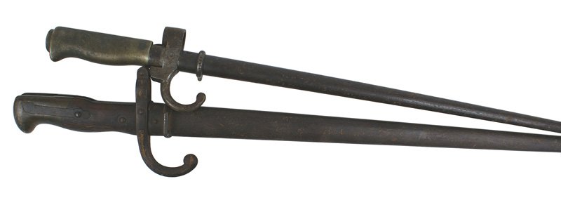 Lot of 2 French bayonets M1874 Epee: D-070 Lot of 2 French bayonets: (1) M1874 "Epee". Wood grip/brass pommel and steel crossguard with a turned-down quillon. 20 3/4" "T-back" blade is dated "1882". Blade has some small gray areas. (2) M