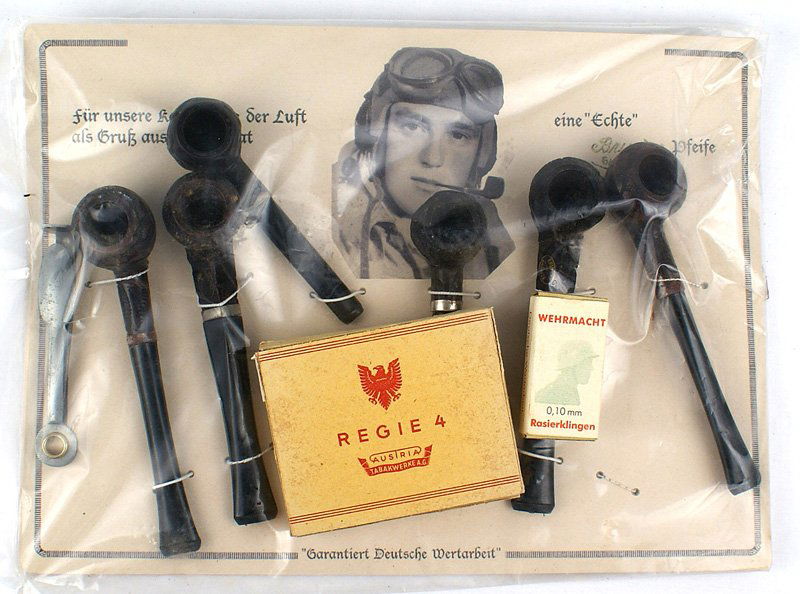 Lot of German WWII miscellaneous pipes etc: H-105 Lot of German WWII miscellaneous items: (1) Original wartime display pipe sales card. 7 3/4" x 10 5/8" hard stock, showing a helmeted pilot smoking a pipe. Also "For our comrades in the air, our