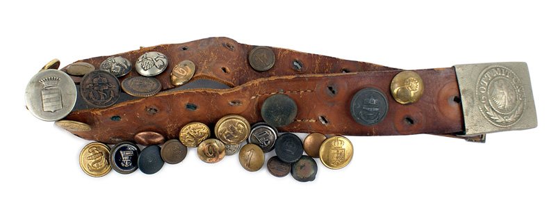 German WWI Souvenir Hate Belt: H-127 Souvenir "Hate Belt". Reichswehr buckle - period eagle/"GOTT MIT UNS"/oak leaves on a pebbled background. 24 1/2" brown leather belt has perforations with 14 affixed buttons (Navy, State, Fire, 