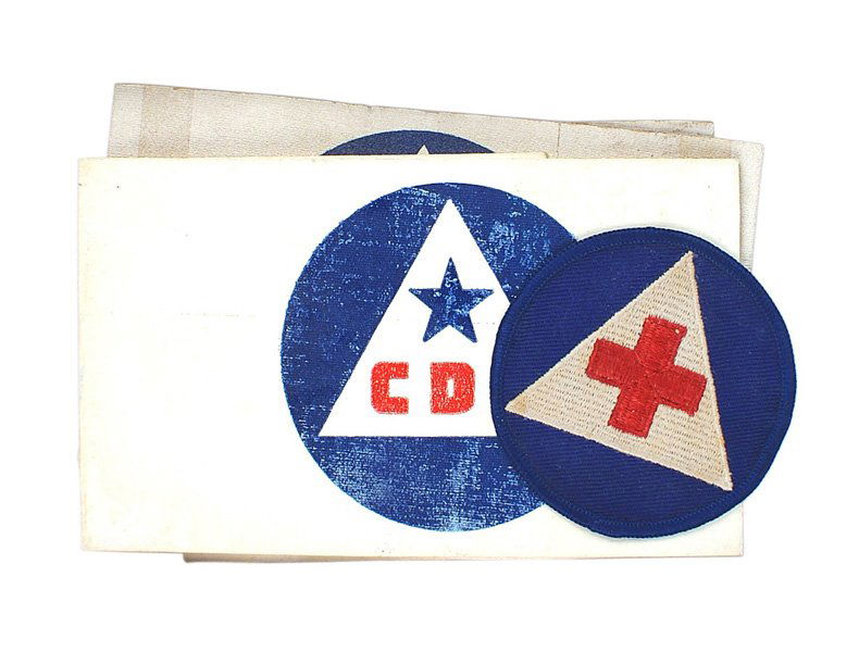 Lot of 3 U.S. WWII Citizens Defense Corps insignia: H-148 Lot of 3 U.S. WWII Citizens Defense Corps insignia: (1) "CDC" armband. Red lettering and blue star on a white triangle with a blue circle - printed on an oil cloth band. (2) Armband with a red M
