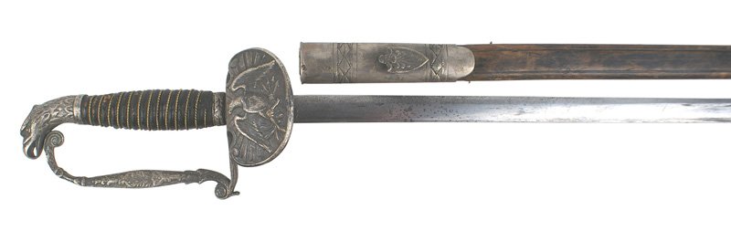 Late Civil War American eagle head sword: K-009 Late American eagle head sword. Twisted wire wrapped leather grip. Silvered defined eagle head pommel. Crudely cast reverse "D" knuckle bow with floral designs. Wide crescent-shaped guard bearin