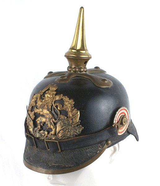 Imperial Hessian NCO 117th Leibregiment helmet: E-004 Imperial German Hessian NCO 117th "Leibregiment". Solid black leather body with surface crazing on the brass trim visor. Age toned gilt brass helmet plate of a crowned standing lion holding a sw