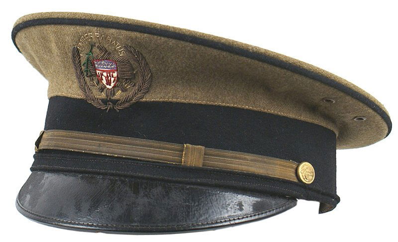 U.S. WWI Coast Guard peaked cap: E-118 U.S. WWI Coast Guard (early Maritime Border Service) Officer's peaked cap. Brown O. D. wool body with black band. Flat gold wire chin strap with Gold Coast Guard buttons. Black leather visor. Re