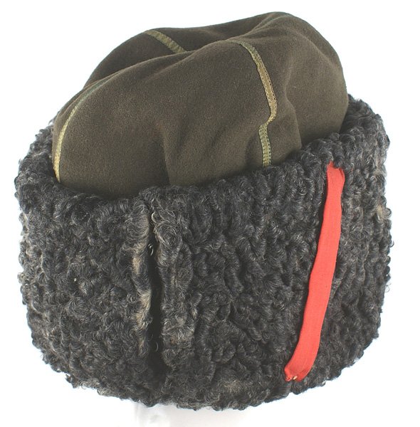 Soviet Russian WWII Cossack winter hat: E-144 Soviet Russian WWII Don Cossach "papacha" winter hat. OD cloth wool body with a ¼" wide gold "tape" across the entire top. A 4 ½" wide gray lambs wool band around the body of the cap is attach