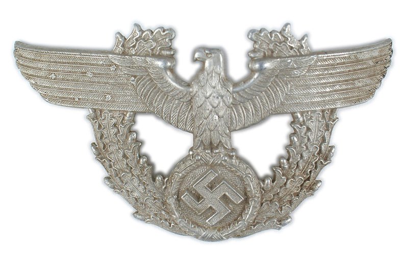 German WWII Police eagle shako plate: E-156 Large metal German WWII Police eagle/swastika shako plate. Convex 3" x 6" eagle on an oak leaf wreath. Two screw posts on reverse. II
