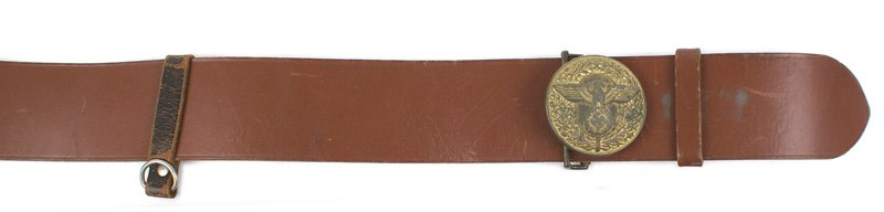 German WWII NSDAP belt and buckle: F-116 N.S.D.A.P. leather belt and buckle. 2 1/4" wide brown leather belt with a slide and two loops with "D" rings. Age darkened gilt round buckle bearing a relief political-type eagle/swastika on an 