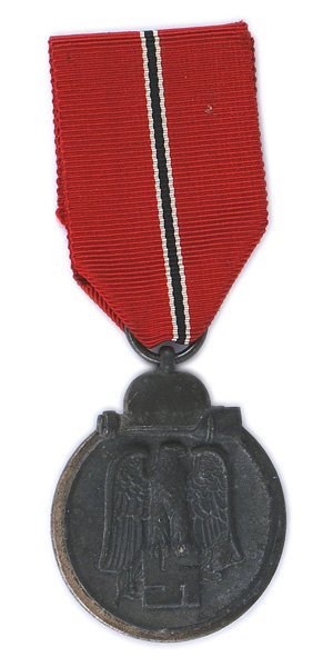 German WWII Eastern Front Medal: B-106 German WWII Eastern Front Medal. Relief black eagle/swastika/oak leaf branch within a silver border and helmet/stick grenade. Reverse: "Winter Campaign in the East 1941-42". II