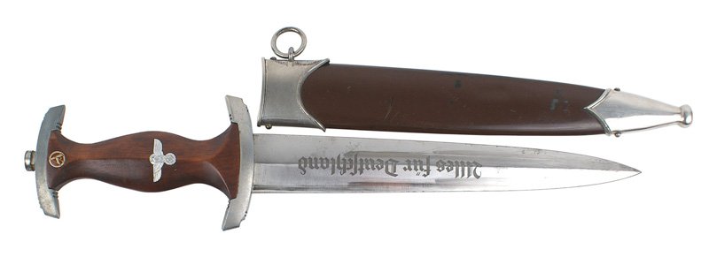 German WWII SA dagger: D-003 German WWII SA dagger. Top crossguard has grayed. Blade retains much of the original finish. Marked "RZM" and "M7/80". 95% of the brown finish remains on the scabbard (two small dents). About II