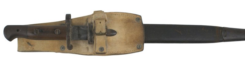 British 1903 pattern bayonet: D-043 British 1903 pattern bayonet. Wood grips with a darkened pommel (stamped "2 CLL -795") and short crossguard/muzzle ring. 11 7/8" double-edged blade is gray with dark patches. Marked with a crown