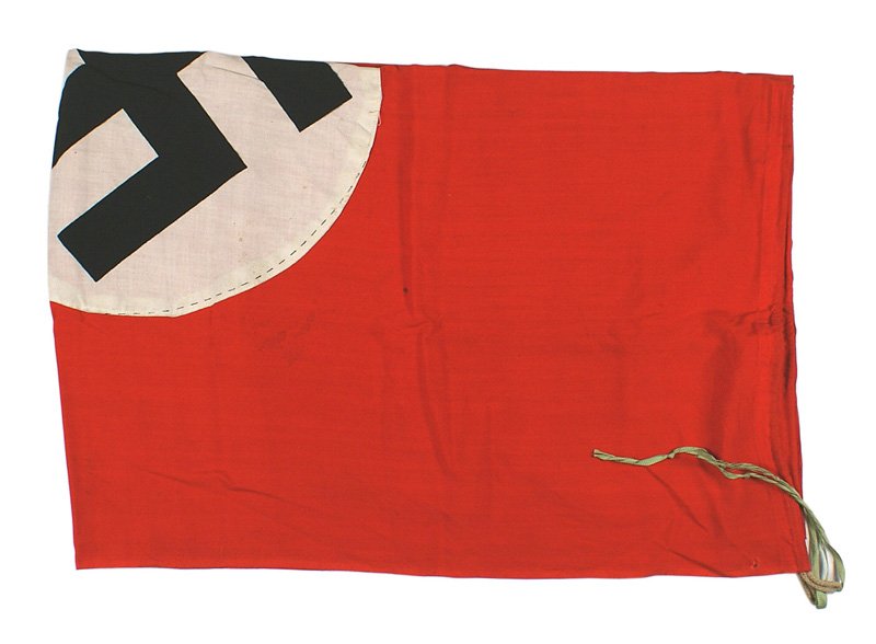 German WWII NSDAP flag: H-077 German WWII NSDAP flag. 31" x 45". Black printed swastika on a white disc sewn to a red field. Two-sided. Rope loops and ribbon ties in two corners. II