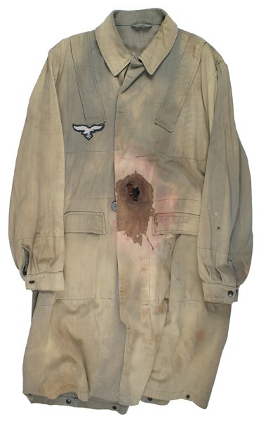Reproduction German WWII Luftwaffe smock: H-209 Reproduction. Luftwaffe light green faded to a tan, paratrooper smock. Four zipper pockets. Fabricated shrapnel hole and bloodstain on left waist area. Luft. eagle/swastika on right breast. Abou